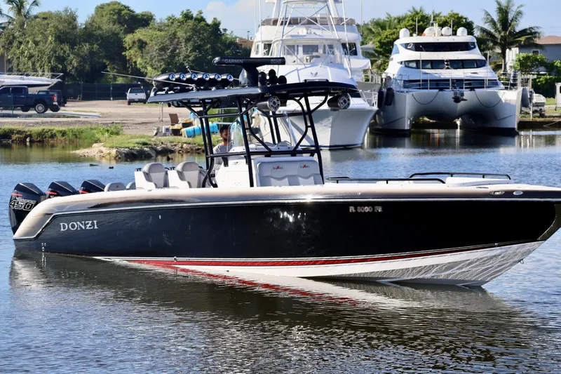  Yacht Photos Pics 2012 Donzi 38 ZF Open boat on water, with powerful engines and sleek design.