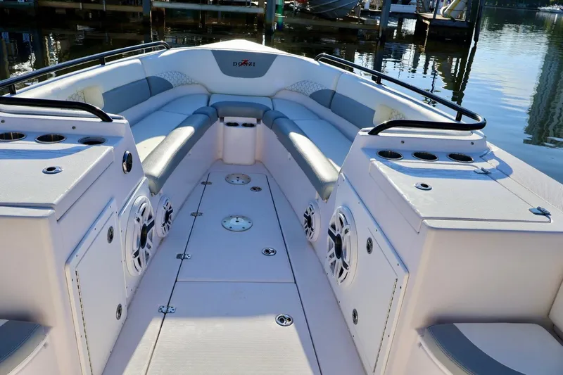  Yacht Photos Pics 2012 Donzi 38 ZF Open boat interior with seating and speakers, docked by the water.