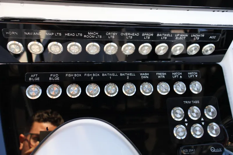  Yacht Photos Pics Control panel of a 2012 Donzi 38 ZF Open boat with labeled switches and buttons.