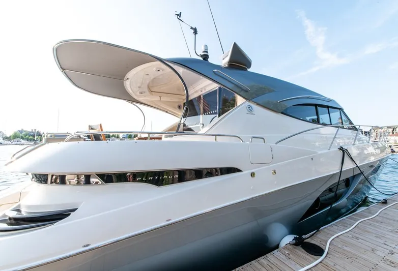 Namari Yacht Photos Pics 2022 Riviera 6000 Sport Yacht Platinum docked, showcasing sleek design and luxury features.