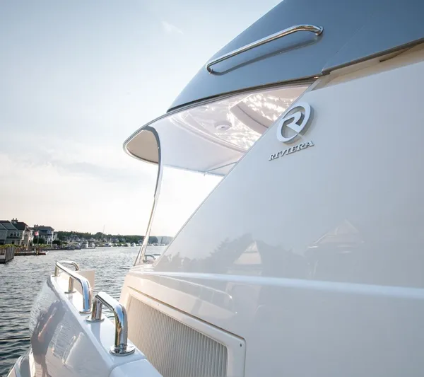 Namari Yacht Photos Pics 2022 Riviera 6000 Sport Yacht Platinum docked, showcasing sleek design and luxury features.