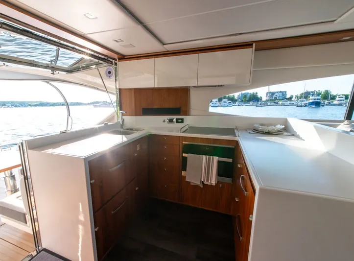 Namari Yacht Photos Pics Luxurious interior of 2022 Riviera 6000 Sport Yacht Platinum with modern kitchen design.