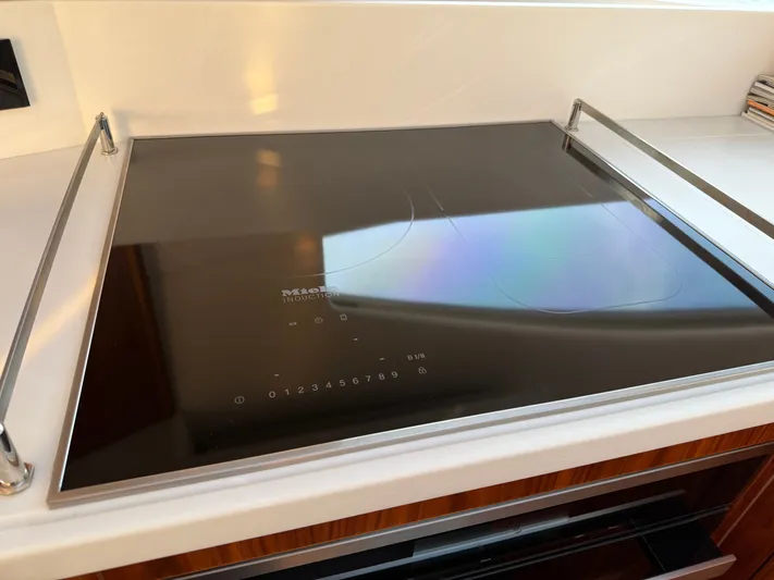 Namari Yacht Photos Pics Miele induction cooktop on 2022 Riviera 6000 Sport Yacht Platinum kitchen.