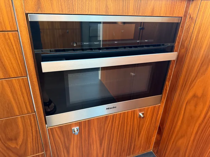 Namari Yacht Photos Pics Built-in Miele microwave in 2022 Riviera 6000 Sport Yacht Platinum kitchen.