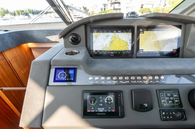 Namari Yacht Photos Pics 2022 Riviera 6000 Sport Yacht Platinum dashboard with navigation screens and controls.