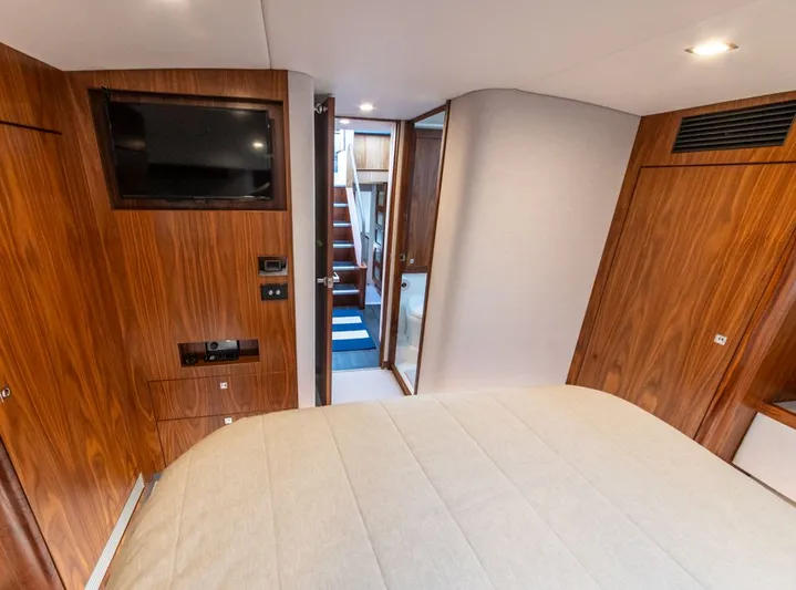 Namari Yacht Photos Pics Interior of 2022 Riviera 6000 Sport Yacht Platinum with wood paneling and modern amenities.
