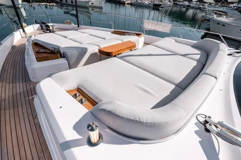  Yacht Photos Pics Luxurious 2024 Azimut Fly 68 yacht deck with plush sun loungers and wooden accents.