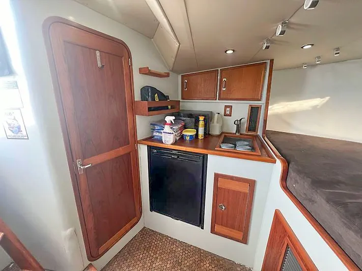 Precedent Yacht Photos Pics Interior of 1998 Jersey Cape 36 Express with kitchenette and storage.
