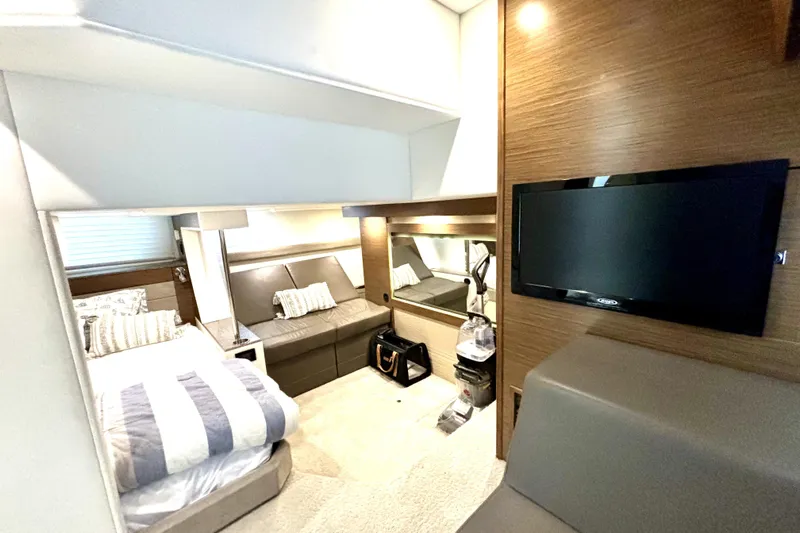  Yacht Photos Pics Luxurious interior of 2014 Cruisers Yachts 45 Cantius with modern furnishings and TV.