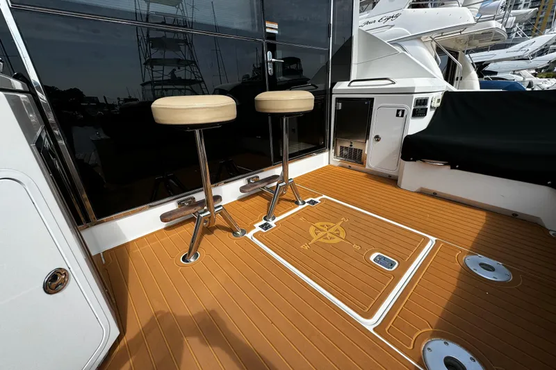  Yacht Photos Pics 2014 Cruisers Yachts 45 Cantius deck with bar stools and teak flooring.