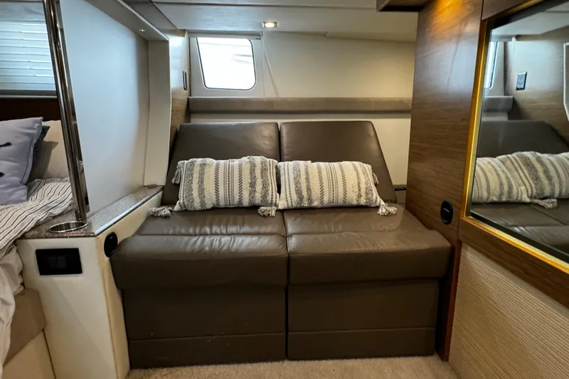  Yacht Photos Pics 2014 Cruisers Yachts 45 Cantius interior with leather seating and decorative pillows.