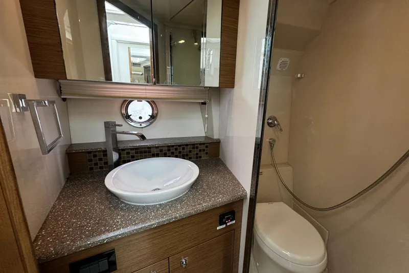  Yacht Photos Pics Luxurious bathroom in 2014 Cruisers Yachts 45 Cantius with modern fixtures and porthole window.