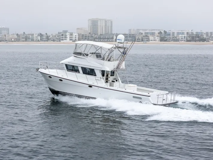  Yacht Photos Pics 2018 Lindell 46 F boat cruising near city shoreline.