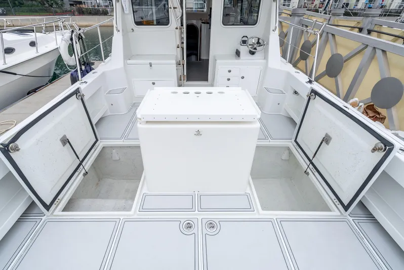  Yacht Photos Pics Lindell 46 F 2018 boat deck with storage compartments open, showcasing spacious design.