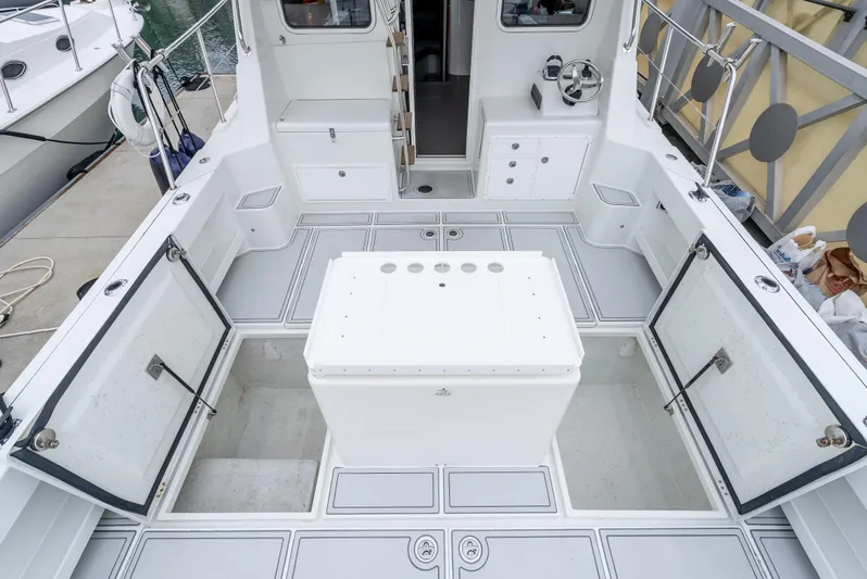  Yacht Photos Pics Spacious deck of 2018 Lindell 46 F boat with storage compartments open.