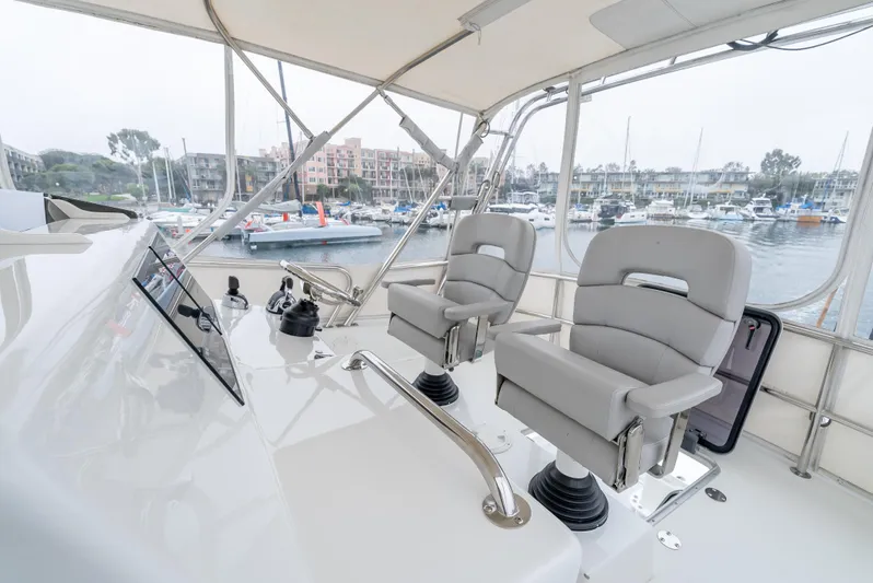  Yacht Photos Pics Lindell 46 F 2018 yacht helm with dual captain chairs in marina setting.