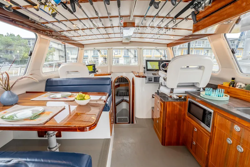  Yacht Photos Pics Luxurious 2018 Lindell 46 F yacht interior with dining area, kitchen, and navigation station.