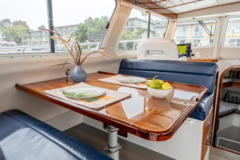  Yacht Photos Pics Interior of 2018 Lindell 46 F boat with elegant dining area and wooden table.