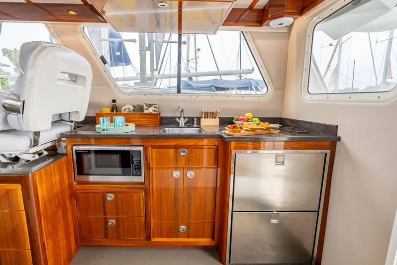  Yacht Photos Pics Luxurious Lindell 46 F yacht kitchen with wood cabinetry, stainless appliances, and scenic windows.