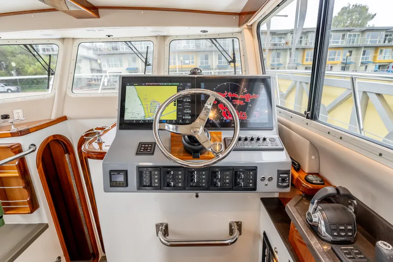  Yacht Photos Pics Helm of 2018 Lindell 46 F boat with navigation equipment and steering wheel.