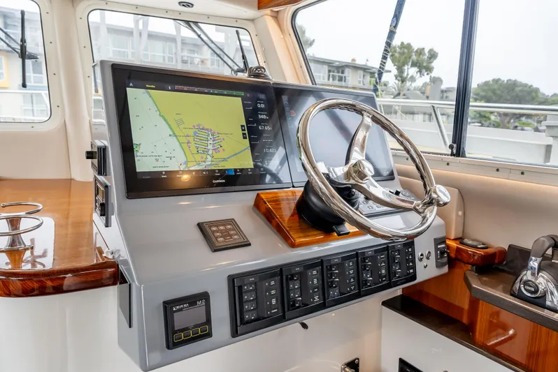  Yacht Photos Pics Lindell 46 F 2018 boat helm with navigation screen and steering wheel.