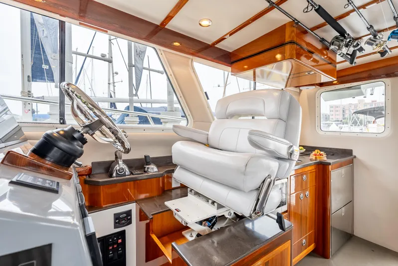  Yacht Photos Pics Luxurious 2018 Lindell 46 F yacht interior with plush captain's chair and wooden cabinetry.