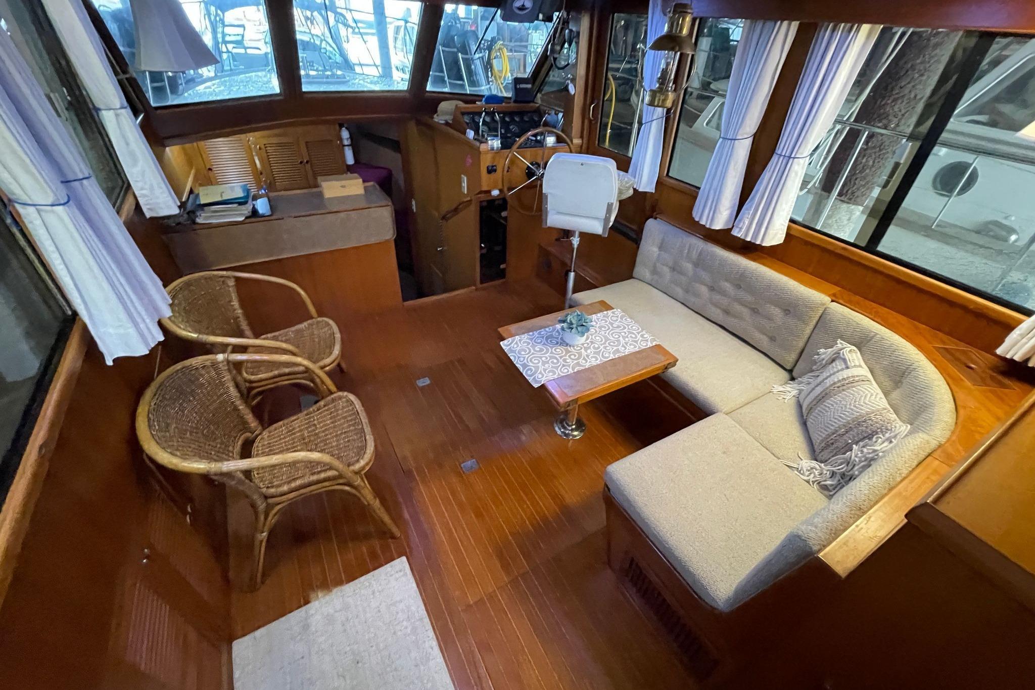 Interior of 1986 NOVA MARINE 36 Sundeck with cozy seating and wooden decor.