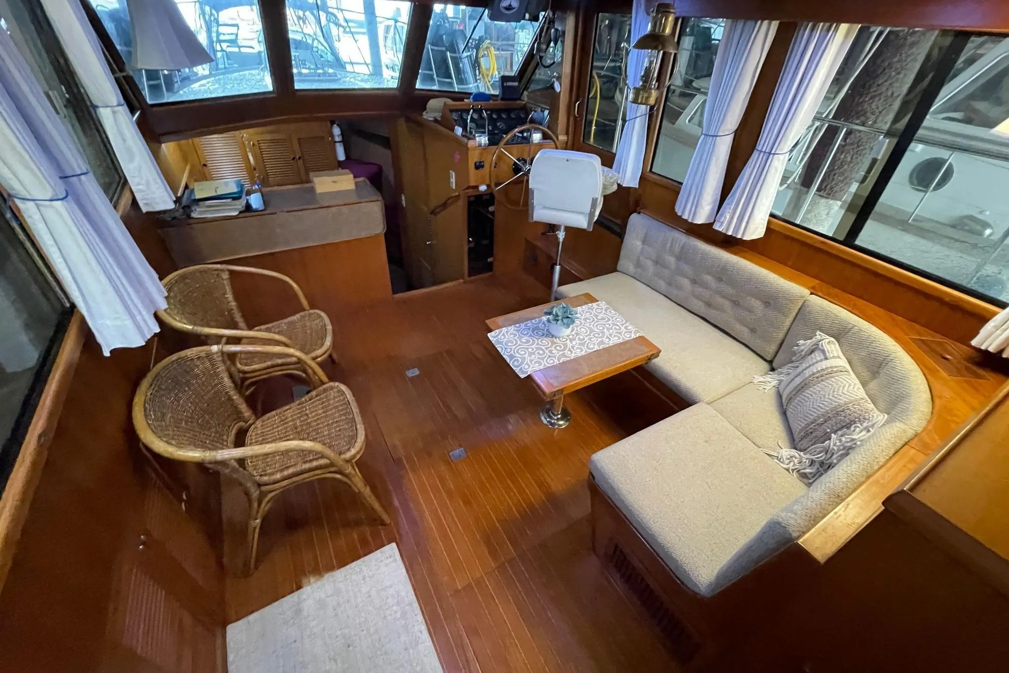 Interior of 1986 NOVA MARINE 36 Sundeck with cozy seating and wooden decor.