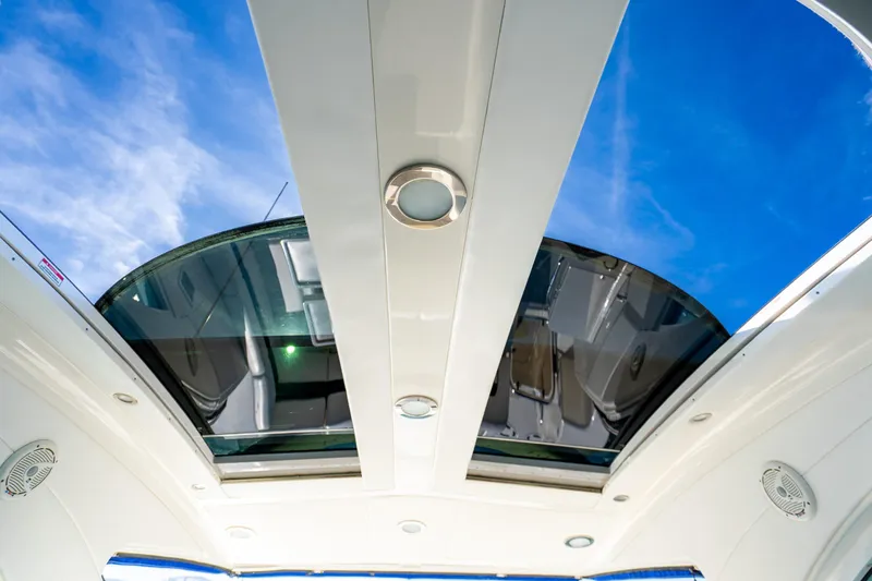  Yacht Photos Pics 2009 Sea Ray 470 Sundancer yacht with open sunroof against blue sky.