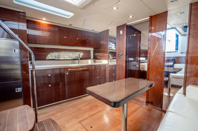  Yacht Photos Pics Luxurious interior of 2009 Sea Ray 470 Sundancer yacht with modern kitchen and dining area.