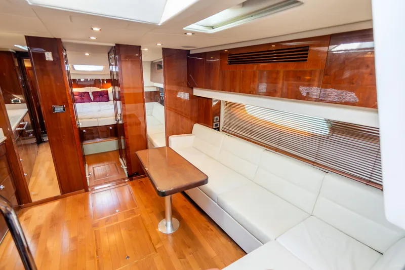  Yacht Photos Pics Luxurious interior of 2009 Sea Ray 470 Sundancer yacht with wood finishes and white seating.