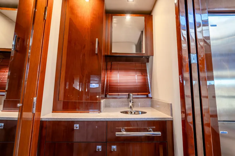  Yacht Photos Pics Luxurious 2009 Sea Ray 470 Sundancer yacht interior with polished wood cabinetry and modern sink.