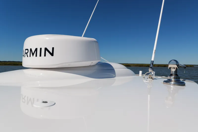 Sea Dawg Yacht Photos Pics 2024 Valhalla Boatworks V-33 with Garmin equipment on deck, clear blue sky background.