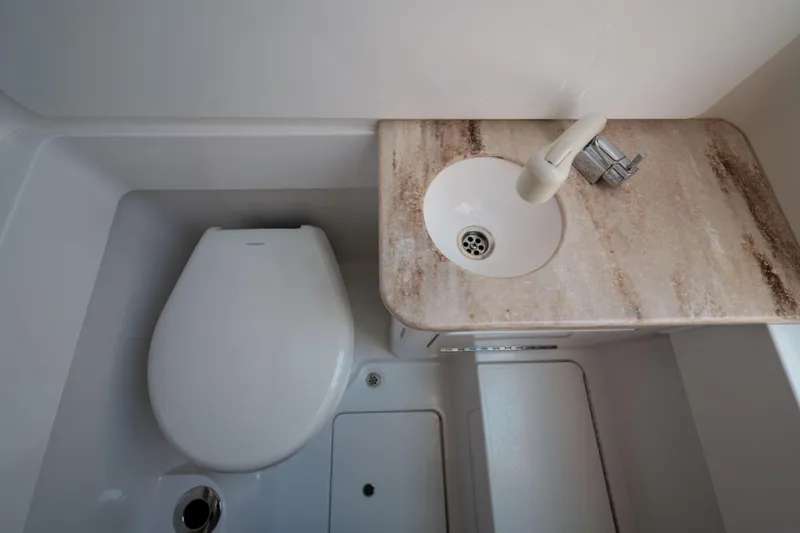 Sea Dawg Yacht Photos Pics 2024 Valhalla V-33 boat bathroom with toilet and marble sink countertop.