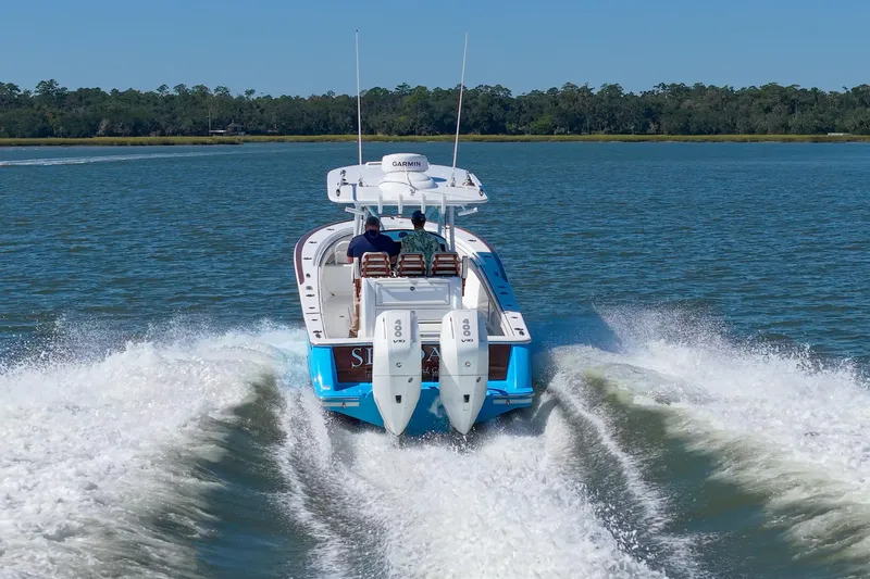 Sea Dawg Yacht Photos Pics 2024 Valhalla Boatworks V-33 cruising on open water, rear view with twin engines.