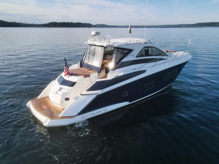 Blue Stiel Yacht Photos Pics 2009 Regal 52 Sport Coupe yacht cruising on calm waters under clear skies.