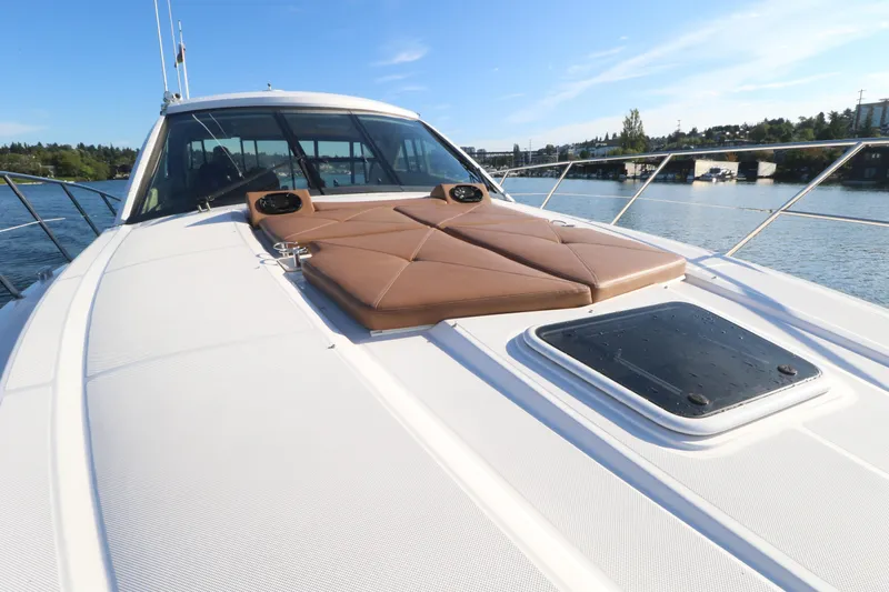 Blue Stiel Yacht Photos Pics 2009 Regal 52 Sport Coupe yacht with sunpad, cruising on a serene waterway.