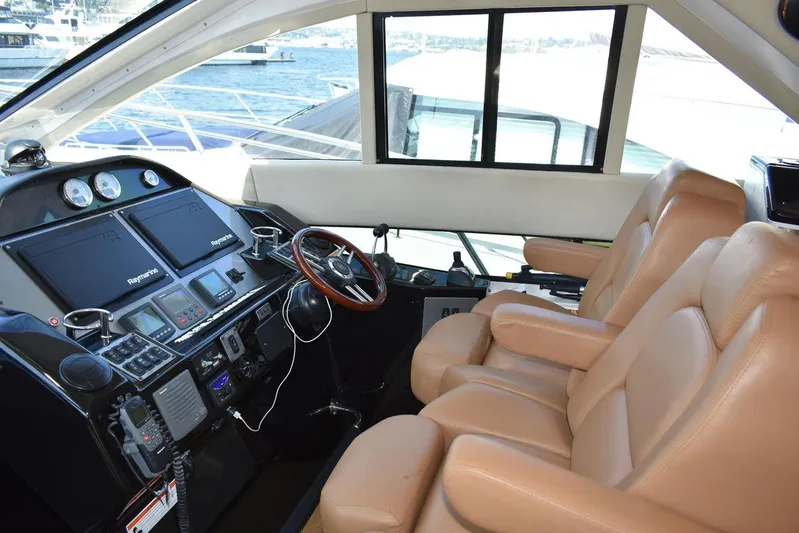 Blue Stiel Yacht Photos Pics Interior of 2009 Regal 52 Sport Coupe yacht with leather seats and modern dashboard.