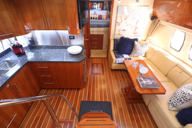 Blue Stiel Yacht Photos Pics Luxurious interior of 2009 Regal 52 Sport Coupe yacht with elegant wood finishes and modern amenities.