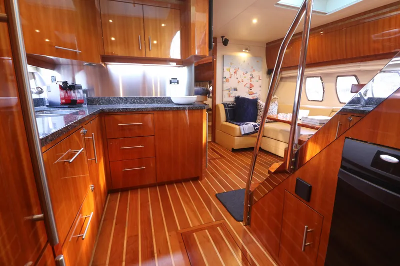 Blue Stiel Yacht Photos Pics Luxurious 2009 Regal 52 Sport Coupe yacht interior with wooden cabinetry and modern amenities.