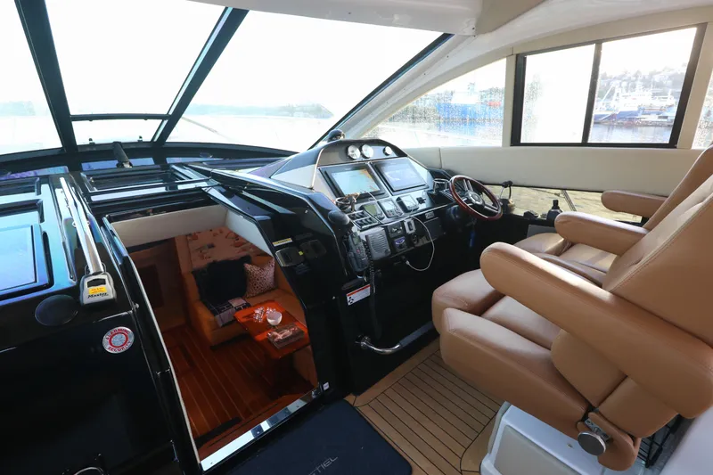 Blue Stiel Yacht Photos Pics Interior of 2009 Regal 52 Sport Coupe yacht with luxurious helm and seating.