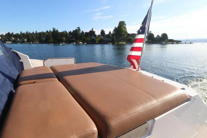 Blue Stiel Yacht Photos Pics 2009 Regal 52 Sport Coupe with American flag on tranquil lake.