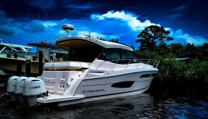 2021 Regal 38 Xo Yacht Photos Pics 2021 Regal 38 XO yacht docked, featuring sleek design and Yamaha engines under a dramatic sky.