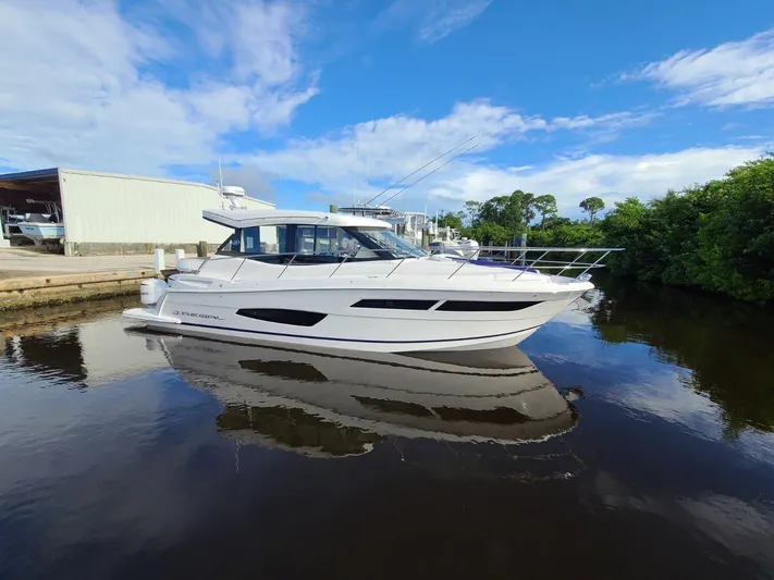 2021 Regal 38 Xo Yacht Photos Pics 2021 Regal 38 XO yacht on calm water under blue sky.