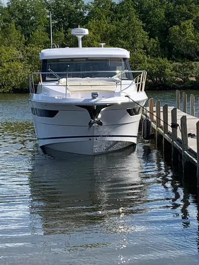 2021 Regal 38 Xo Yacht Photos Pics 2021 Regal 38 XO yacht docked on calm water with lush greenery in the background.