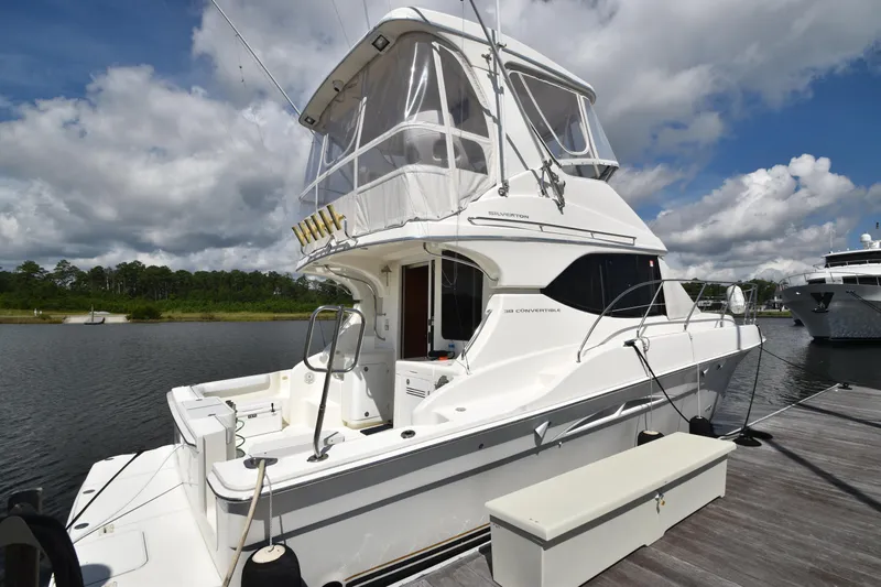 Sea Marie Yacht Photos Pics 2007 Silverton 38 Convertible yacht docked by a serene waterfront.