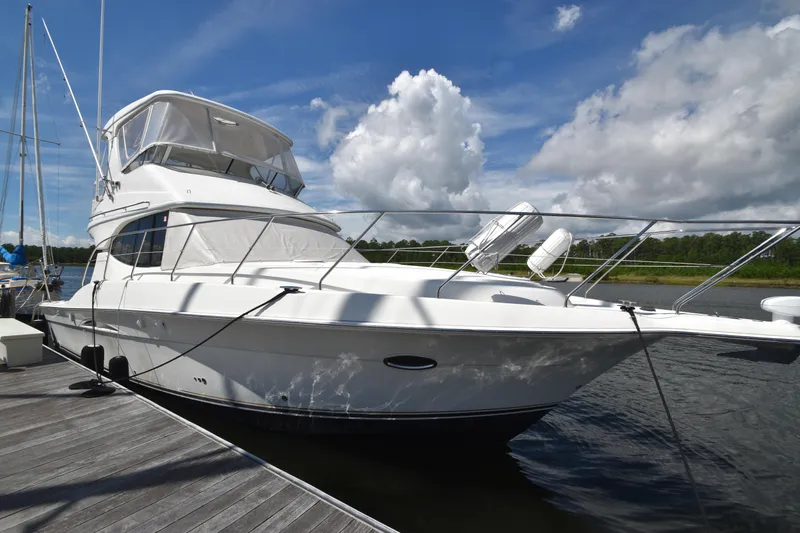 Sea Marie Yacht Photos Pics 2007 Silverton 38 Convertible yacht docked under a blue sky with clouds.