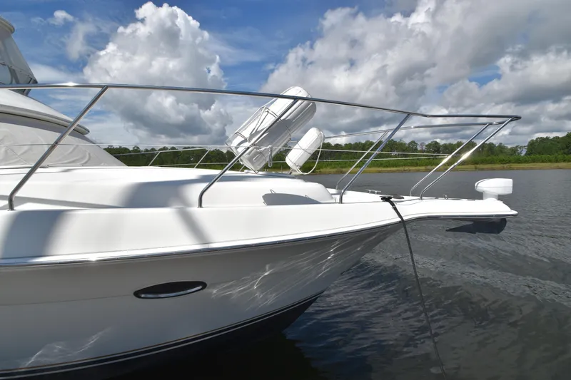 Sea Marie Yacht Photos Pics 2007 Silverton 38 Convertible yacht on calm water under a partly cloudy sky.