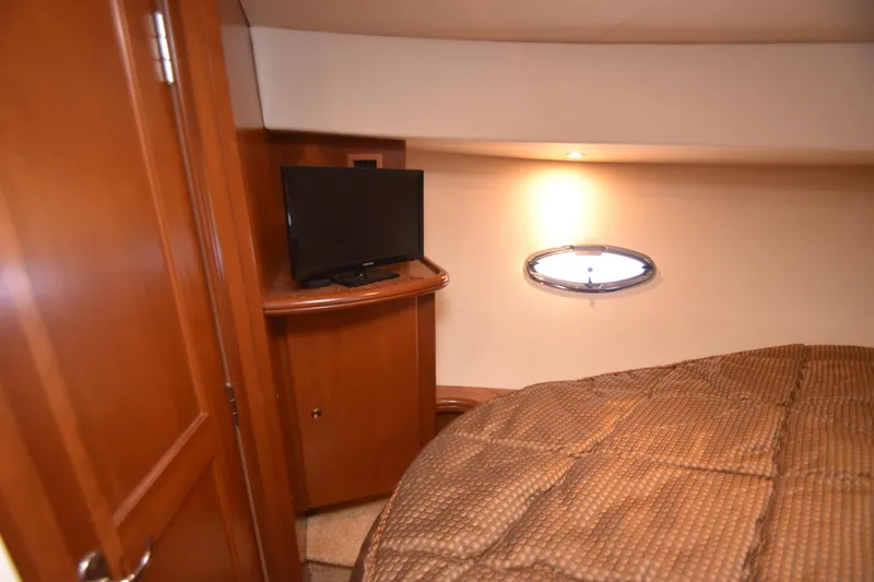 Sea Marie Yacht Photos Pics Cozy cabin interior of 2007 Silverton 38 Convertible with TV and porthole window.