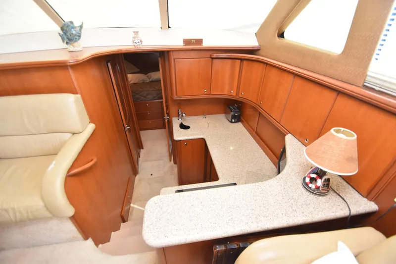 Sea Marie Yacht Photos Pics 2007 Silverton 38 Convertible yacht interior with wood cabinetry and beige seating.